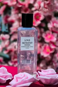 Brume parfumée Love Moment d'Emmanuelle Jane Paris dans un flacon transparent, entourée de fleurs de cerisier roses.
