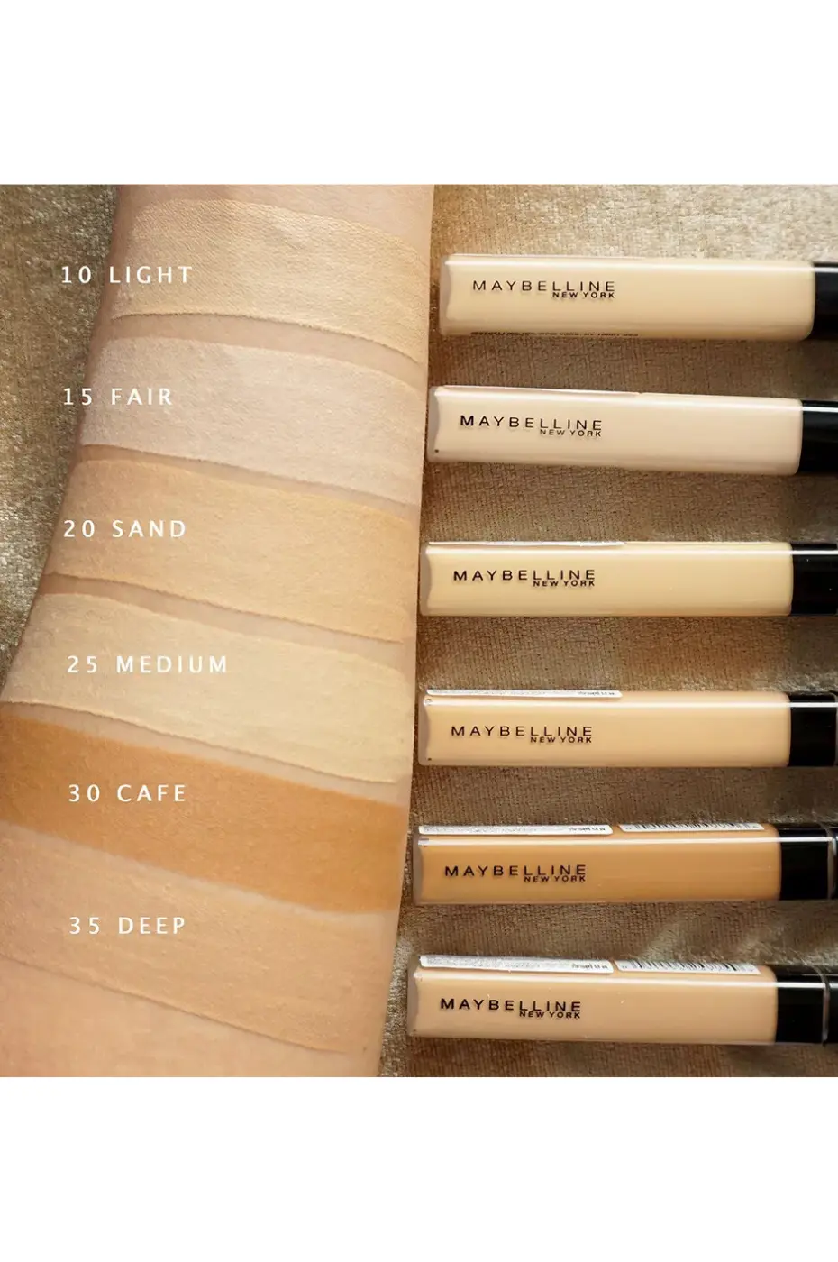 Palette Fit Me : Échantillons de Teintes de Correcteur Échantillons de six teintes du correcteur Maybelline Fit Me (10 Light à 35 Deep) sur un bras. Les tubes produits sont alignés à droite.