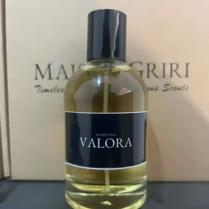 Flacon du parfum féminin VALORA (Maison Griri) 100ml sur fond marron. Liquide ambré.