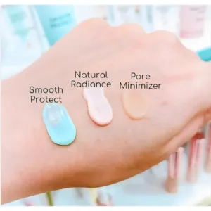 Trois noisettes de base Topface sur une main : Smooth Protect bleue, Natural Radiance rose et Pore Minimizer beige.