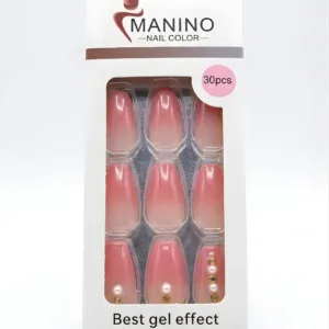 Boîte de 30 faux ongles Manino dégradé rose et nude, effet gel brillant avec ornements perles et strass dorés sur fond blanc.