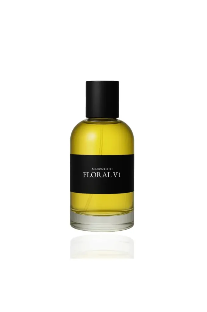 Flacon en verre de l'eau de parfum Maison Griri Floral V1 pour femme, liquide doré, bouchon noir.